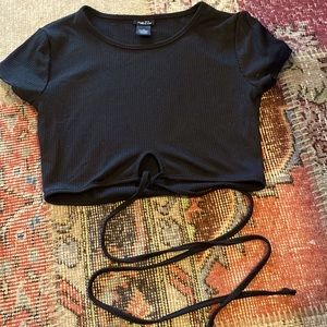 This is a medium black rue 21 crop top with black strings that wraps around.